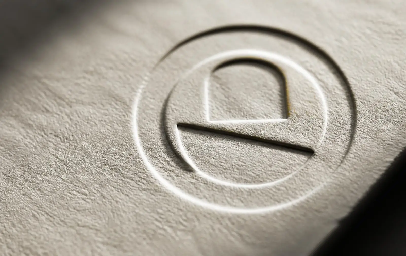 Embossed circular company seal pressed into thick cream paper